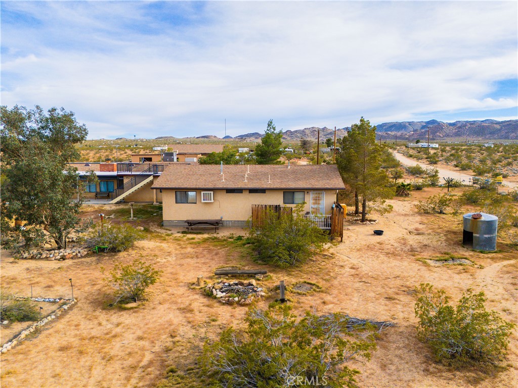 5975 Desert Star Road Johnson Valley, CA 92285 - Photo 63 of 74 a view of a big house with a big yard and large trees