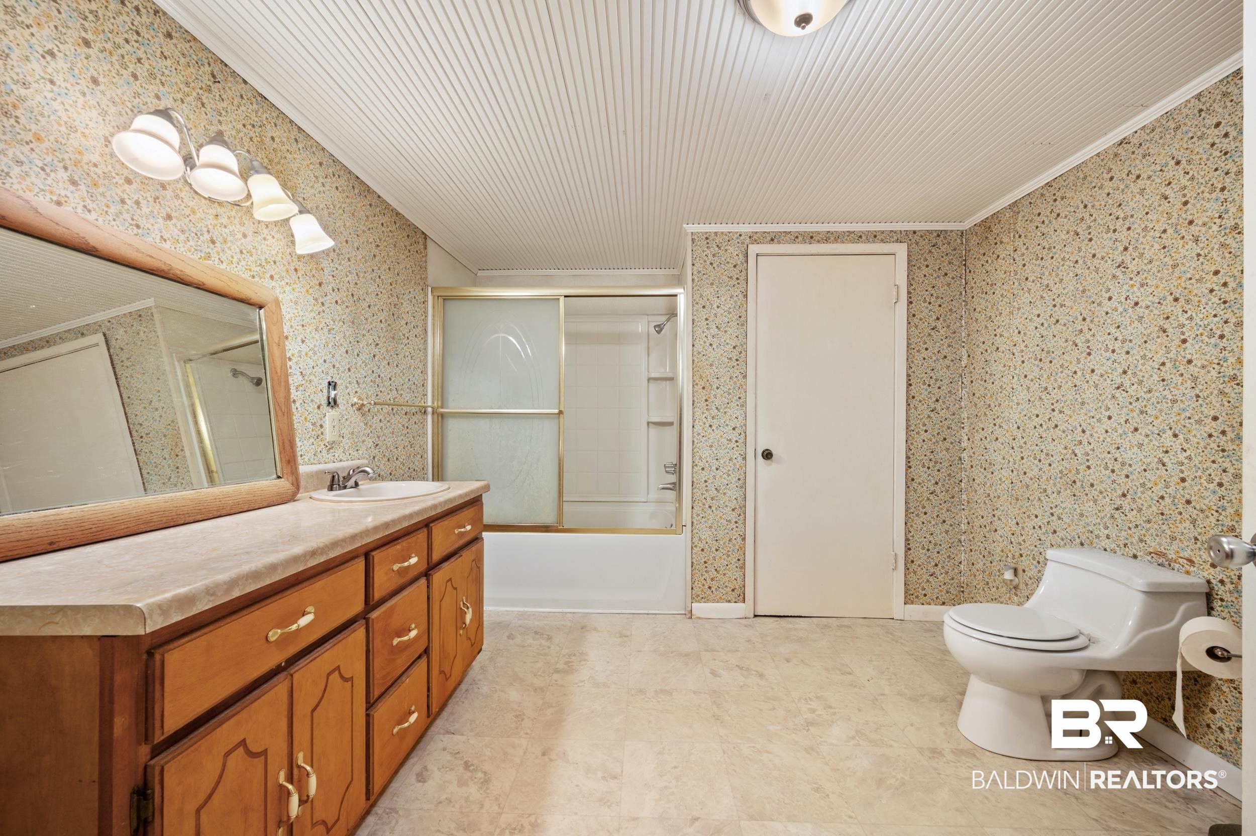 57623 Mary Hadley Road Perdido, AL 36562 - Photo 16 of 34 Bathroom featuring enclosed tub / shower combo, wallpapered walls, vanity, and crown molding