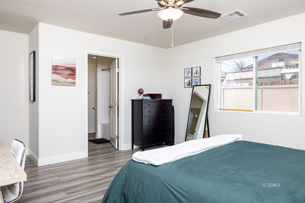 1229 South Ranger Street Ridgecrest, CA 93555 - Photo 24 of 36 a bedroom with a bed and wooden floor