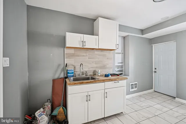 a kitchen with a sink stove and cabinets