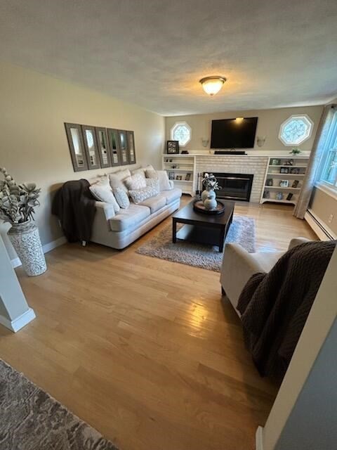 28 Emory Street Saugus, MA 01906 - Photo 2 of 34 a living room with furniture and a flat screen tv