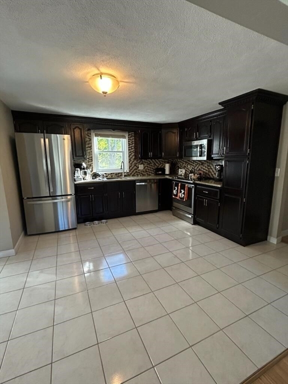 28 Emory Street Saugus, MA 01906 - Photo 31 of 34 a kitchen with stainless steel appliances granite countertop a refrigerator and a sink