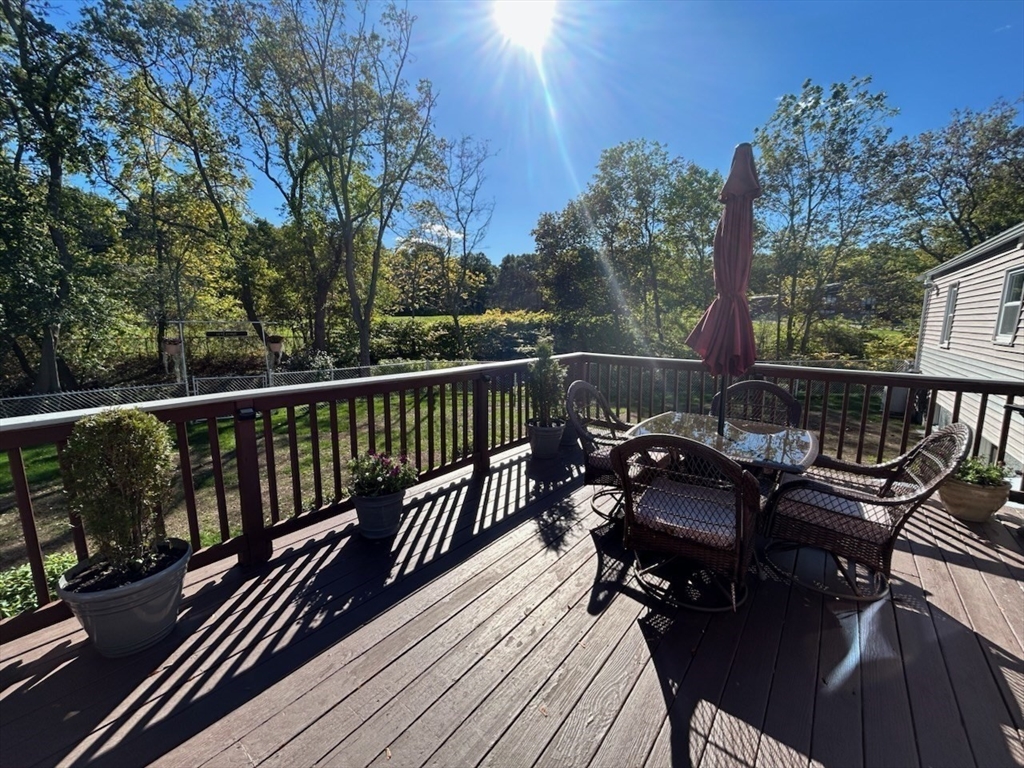 28 Emory Street Saugus, MA 01906 - Photo 5 of 34 a view of a roof deck with table and chairs with wooden floor and fence