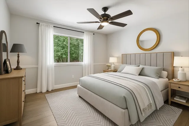 a bedroom with a large bed and a chandelier