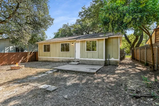 a view of a yard with a house and a tree