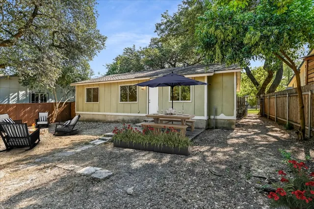 a view of a house with backyard and sitting area