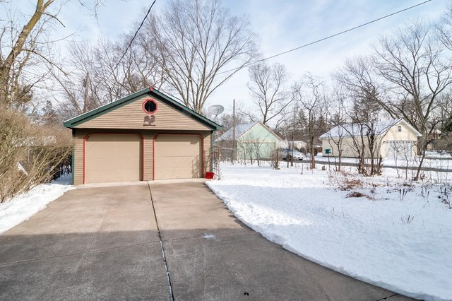 264 Shenstone Road Riverside, IL 60546 - Photo 8 of 9 a front view of a house with a yard covered with snow