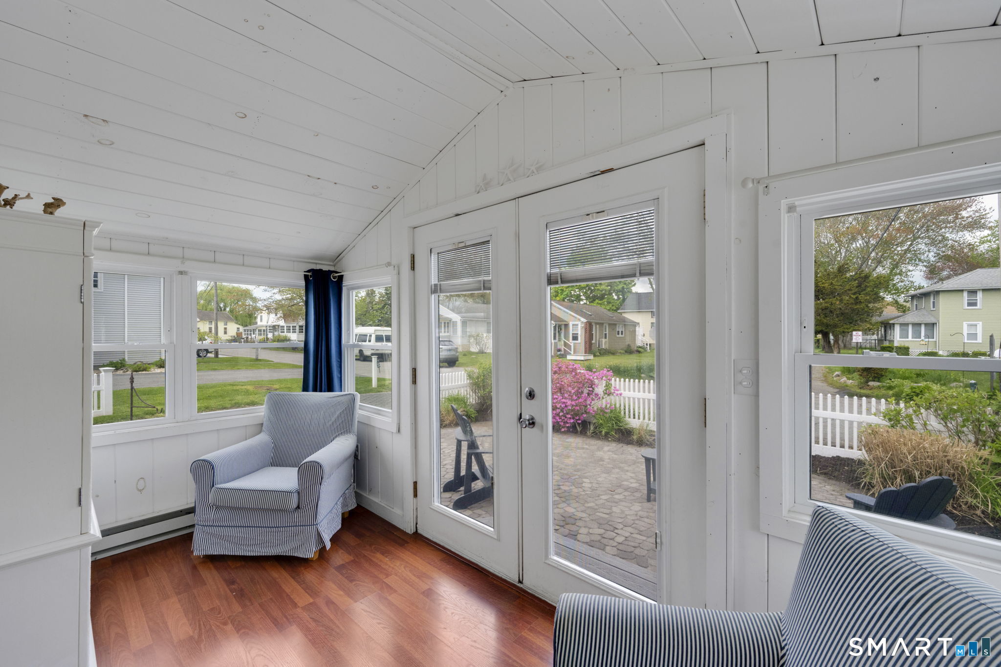 96 Chalker Beach Road Old Saybrook, CT 06475 - Photo 26 of 33 a living room with furniture and a large window with outer view