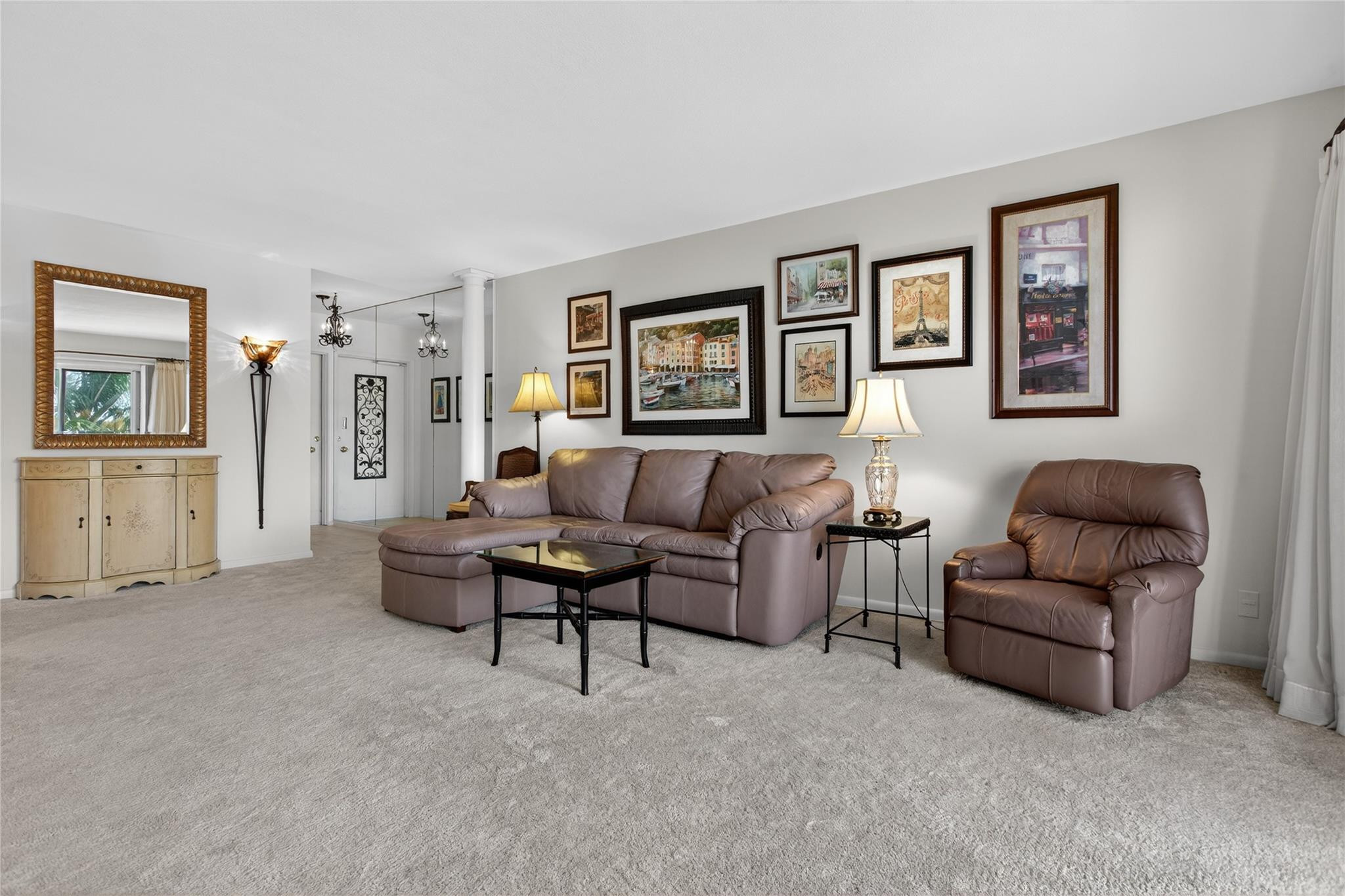 1001 North Riverside Drive, Unit 305 Pompano Beach, FL 33062 - Photo 12 of 44 a living room with furniture and a wall painting