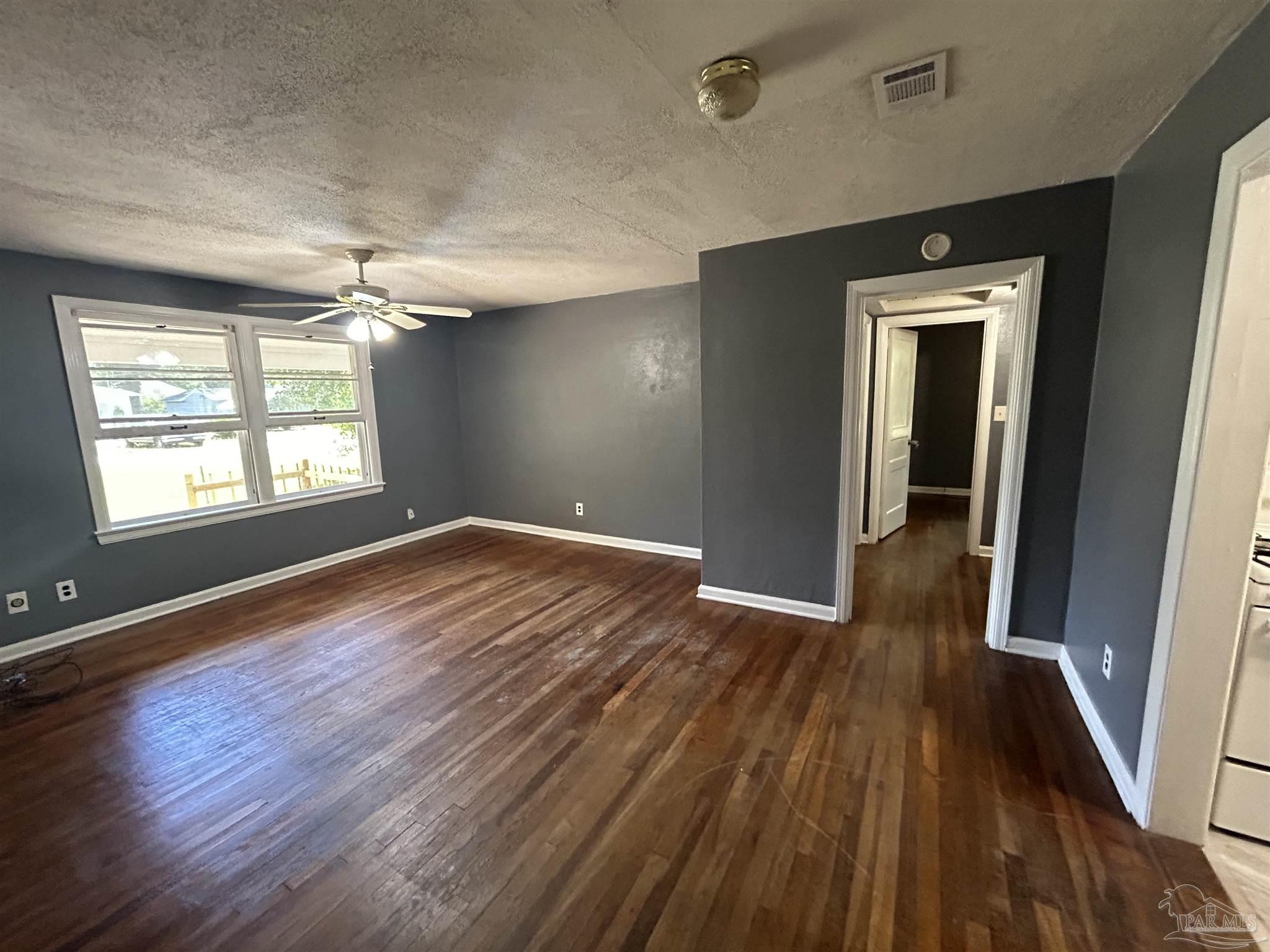 210 Milton Road Pensacola, FL 32507 - Photo 6 of 17 wooden floor in an empty room with a window