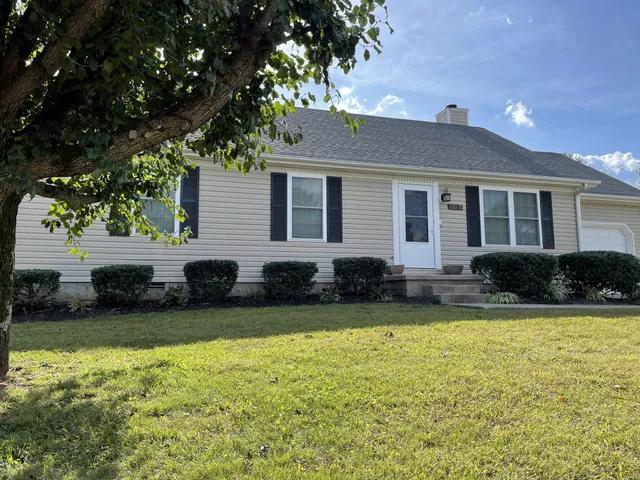 a view of a house with swimming pool and a yard