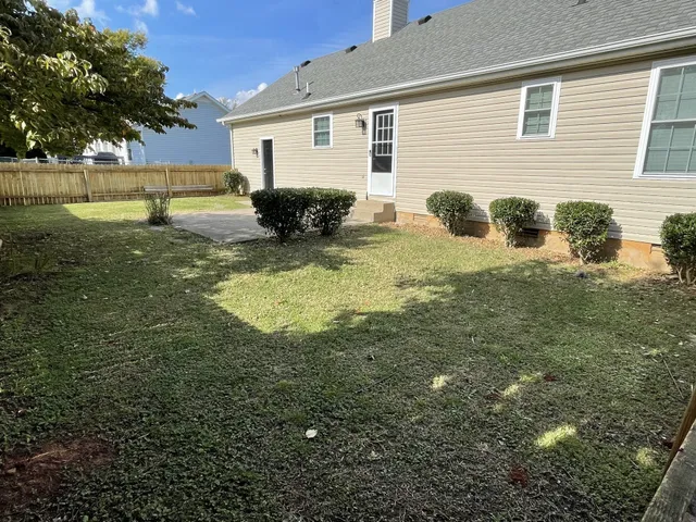 a view of backyard of house with outdoor seating