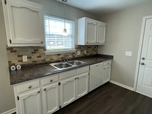 a kitchen with sink cabinets and window