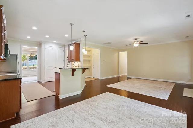 a view of kitchen with cabinets and wooden floor