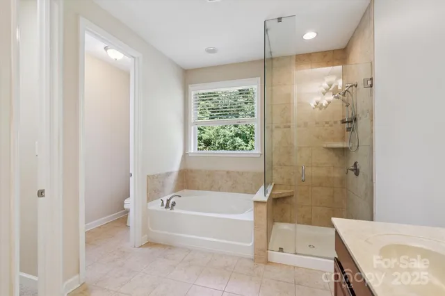a spacious bathroom with a bathtub and a shower
