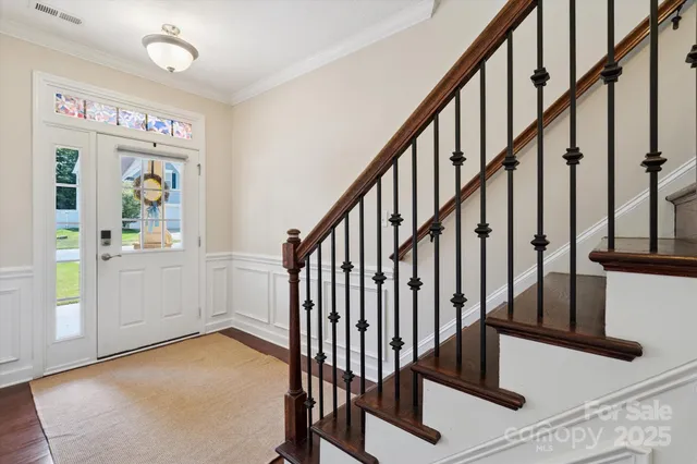 a view of an entryway with wooden floor and stairs