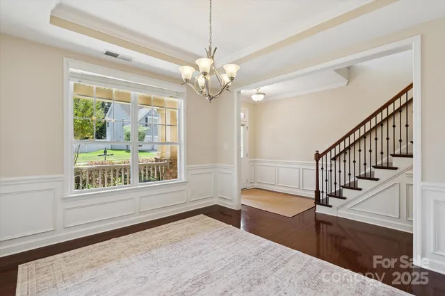 a view of an entryway with wooden floor and a chandelier