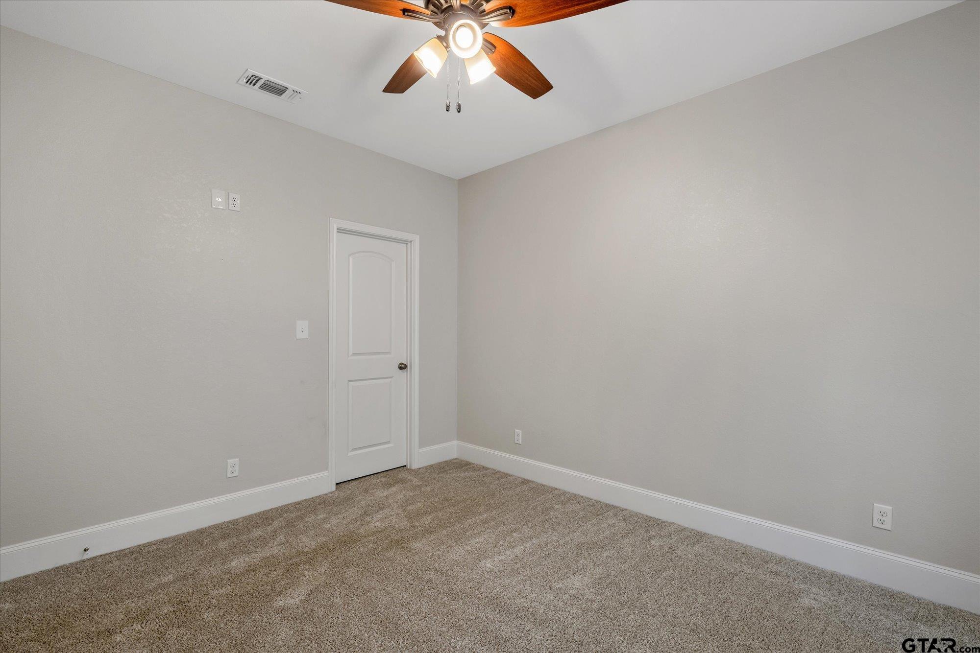150 County Road 3602 Bullard, TX 75757 - Photo 24 of 35 an empty room with a chandelier fan and windows