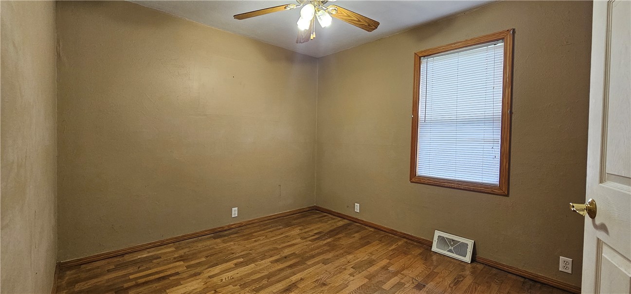 206 East Fifth Street St. Peter, IL 62880 - Photo 11 of 23 en empty room with wooden floor and fan
