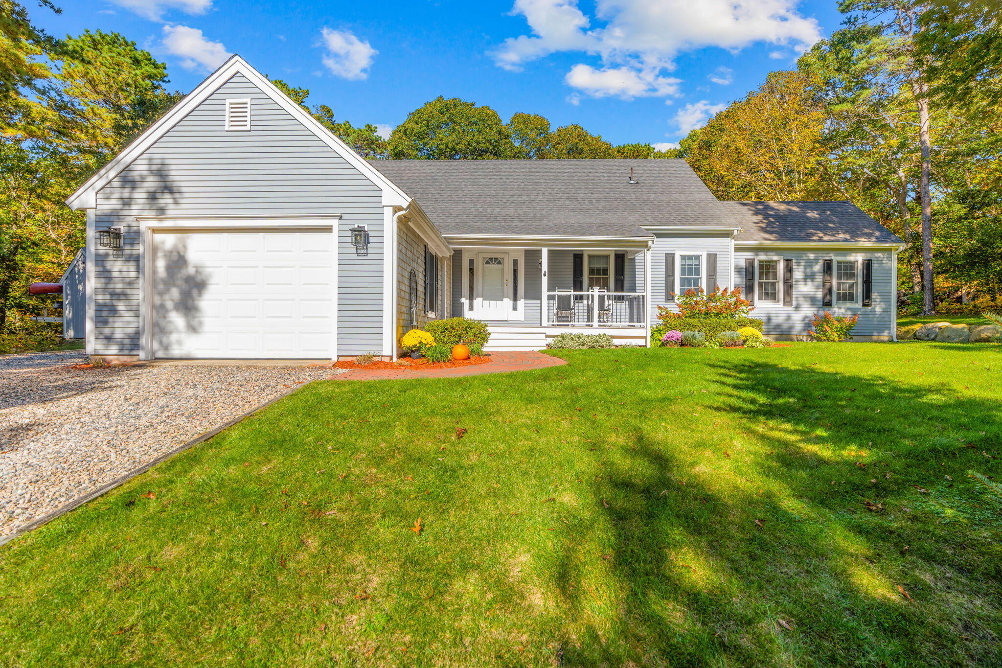 718 Cedar Street West Barnstable, MA 02668 - Photo 1 of 40 a front view of a house with a yard table and chairs