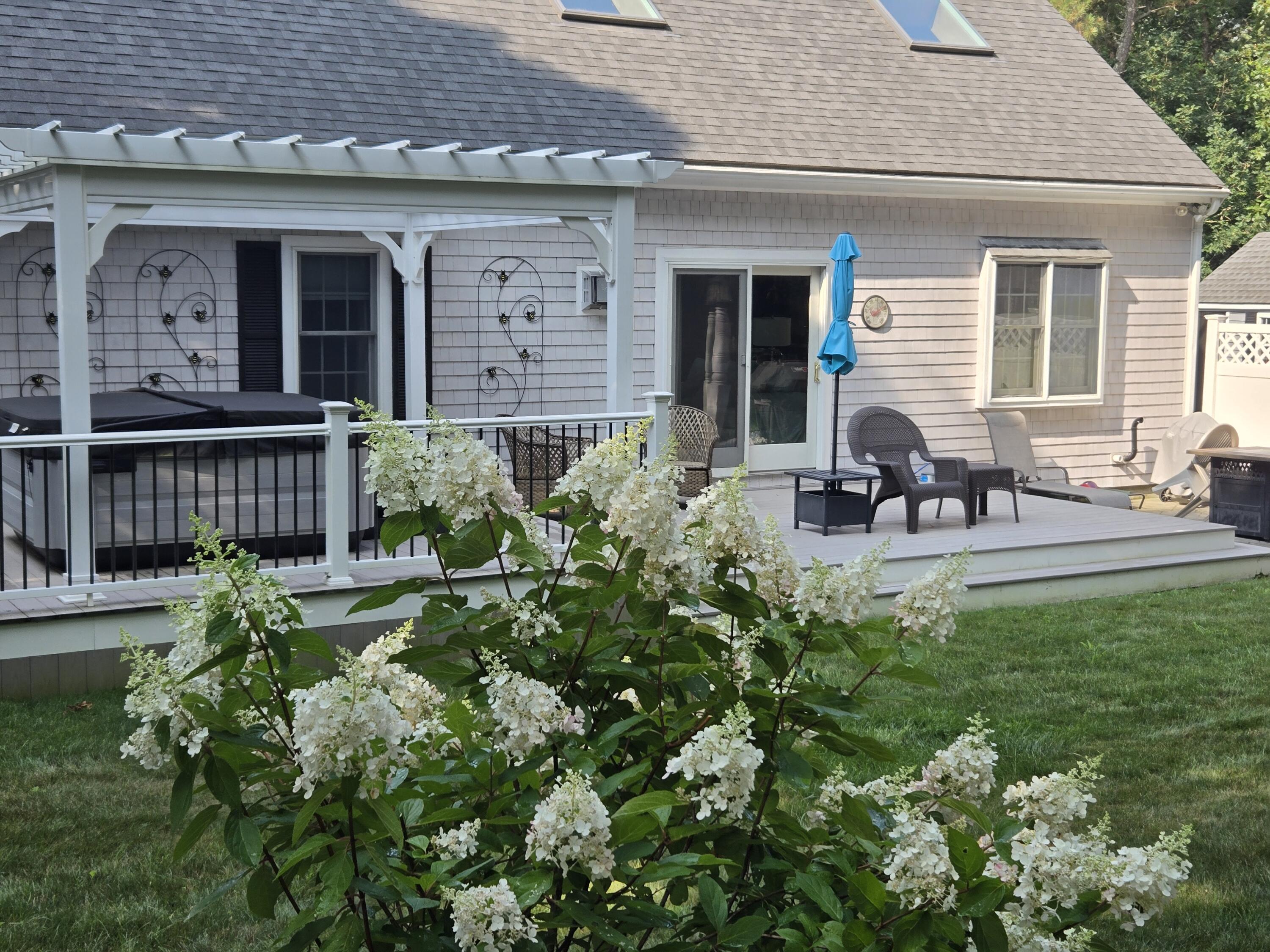 718 Cedar Street West Barnstable, MA 02668 - Photo 11 of 40 a view of a house with sitting area and garden