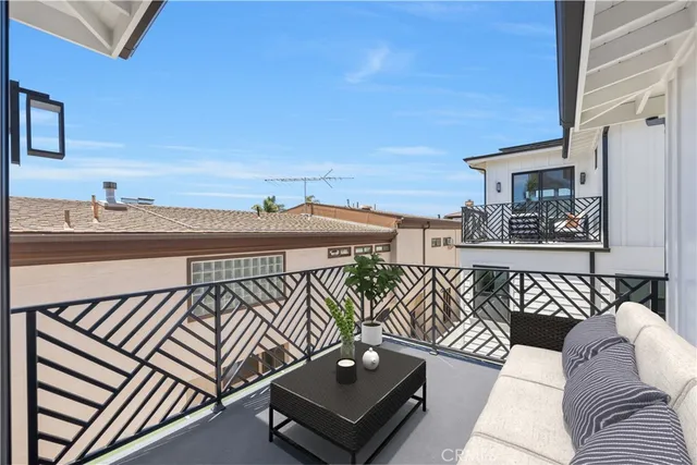 a large kitchen with stainless steel appliances kitchen island granite countertop a stove a sink a refrigerator and white cabinets with wooden floor