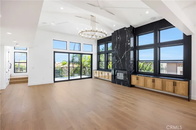 a large kitchen with stainless steel appliances granite countertop a sink a stove and a wooden floors