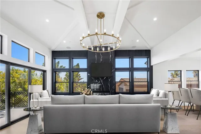 a living room with furniture large windows and outer view