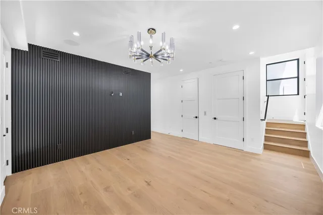 an empty room with windows and mirror