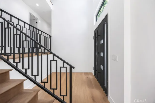 a view of a kitchen with sink and mirror