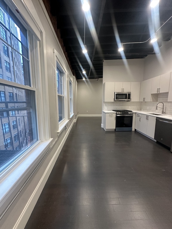 281 Franklin Street, Unit 602 Boston, MA 02110 - Photo 2 of 10 a view of a kitchen with furniture and a kitchen