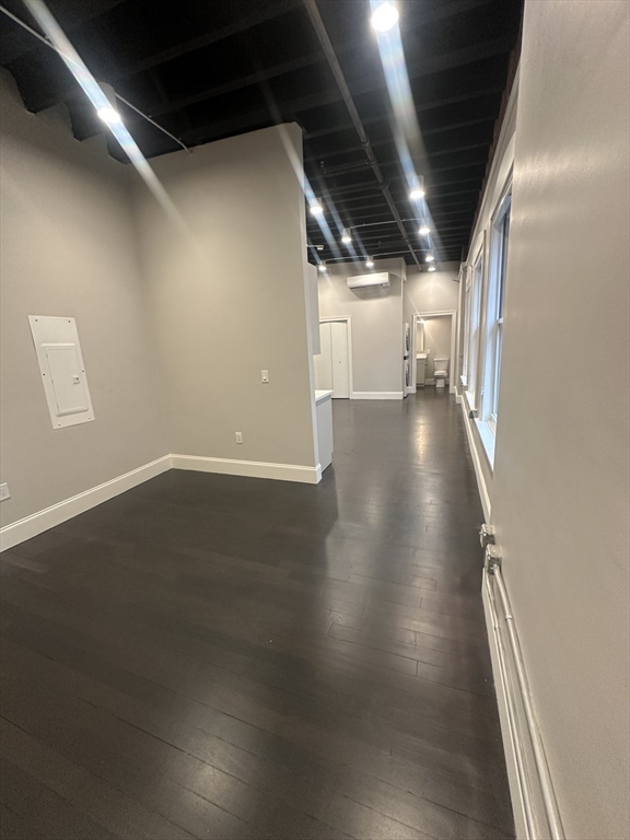 281 Franklin Street, Unit 602 Boston, MA 02110 - Photo 7 of 10 an empty room with wooden floor and windows
