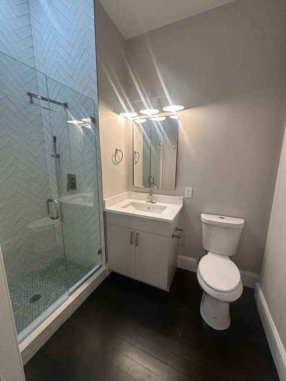 281 Franklin Street, Unit 602 Boston, MA 02110 - Photo 8 of 10 a bathroom with a toilet sink and shower