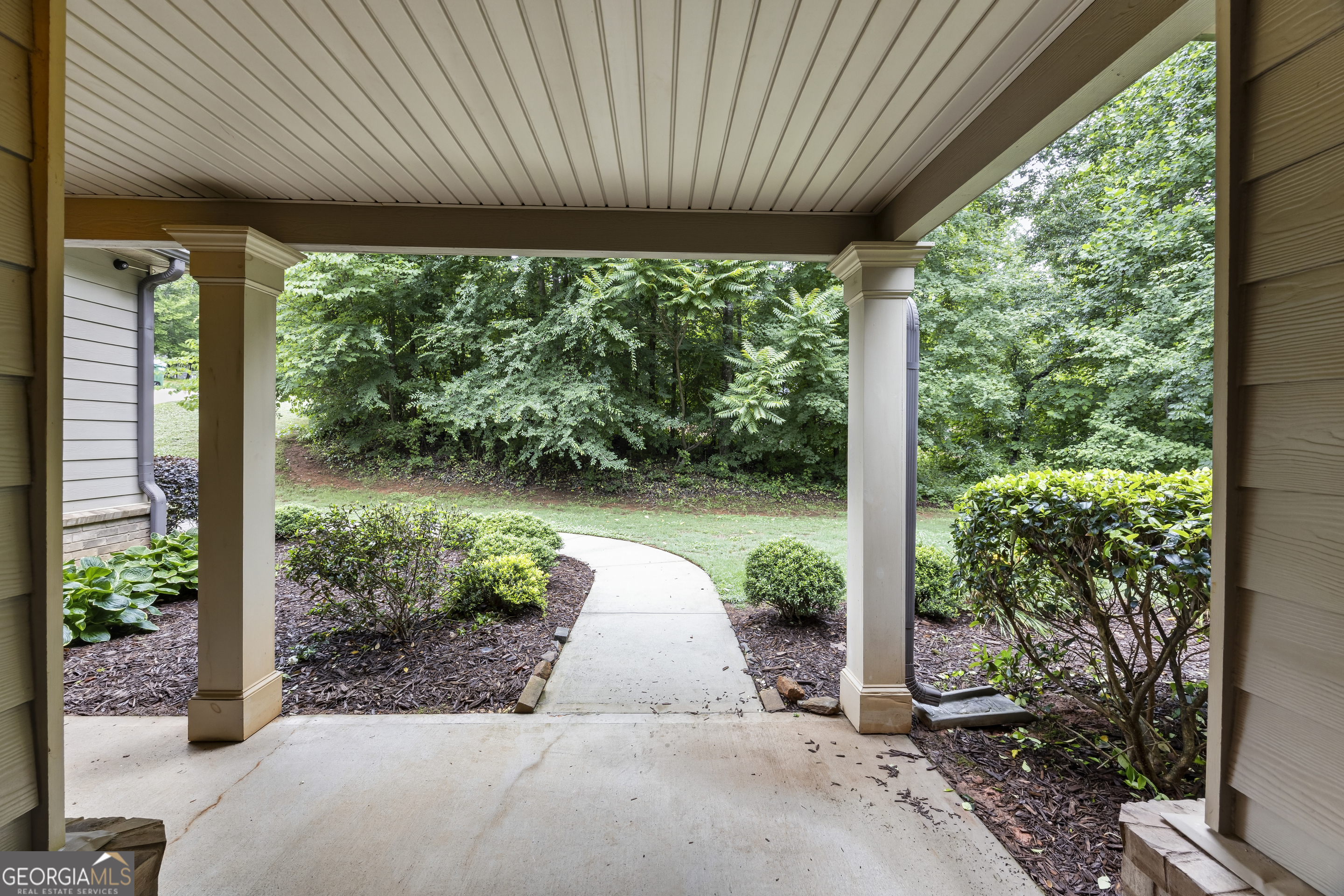717 Oconee Lane Commerce, GA 30529 - Photo 9 of 57 a view of a patio with table and chairs under an umbrella