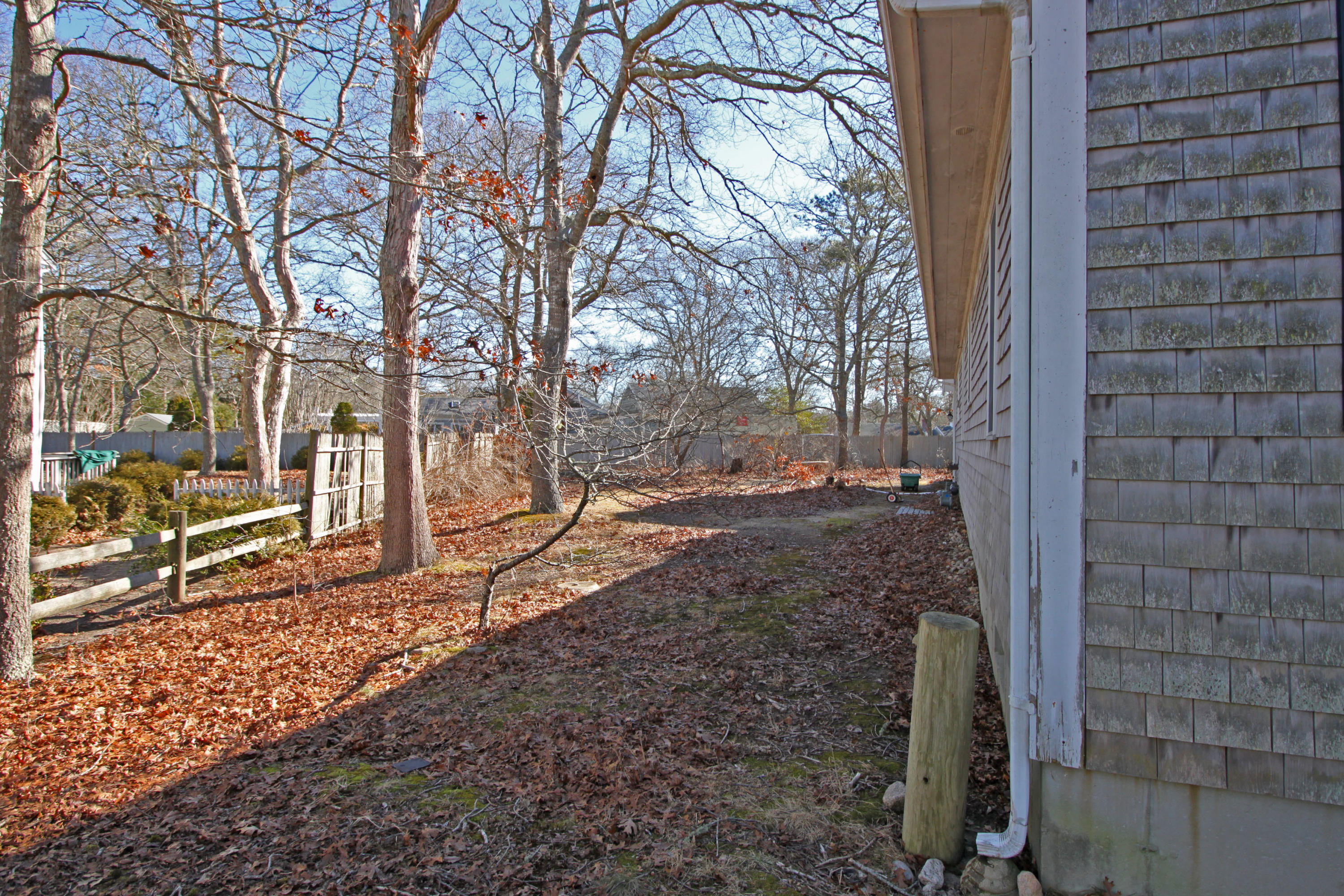 52 Moon Penny Lane Centerville, MA 02632 - Photo 3 of 12 a view of a yard covered in snow