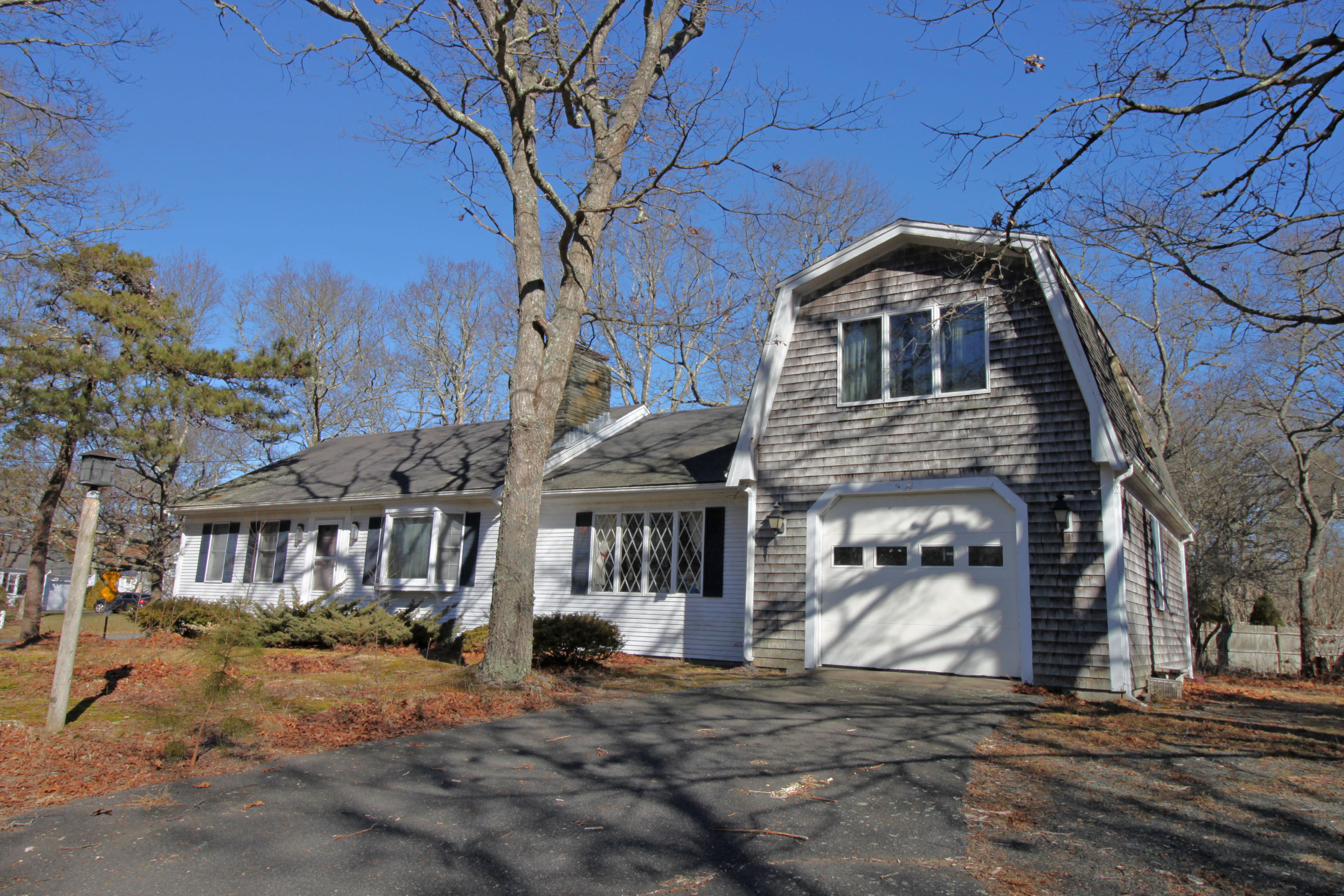 52 Moon Penny Lane Centerville, MA 02632 - Photo 6 of 12 a front view of a house with a yard