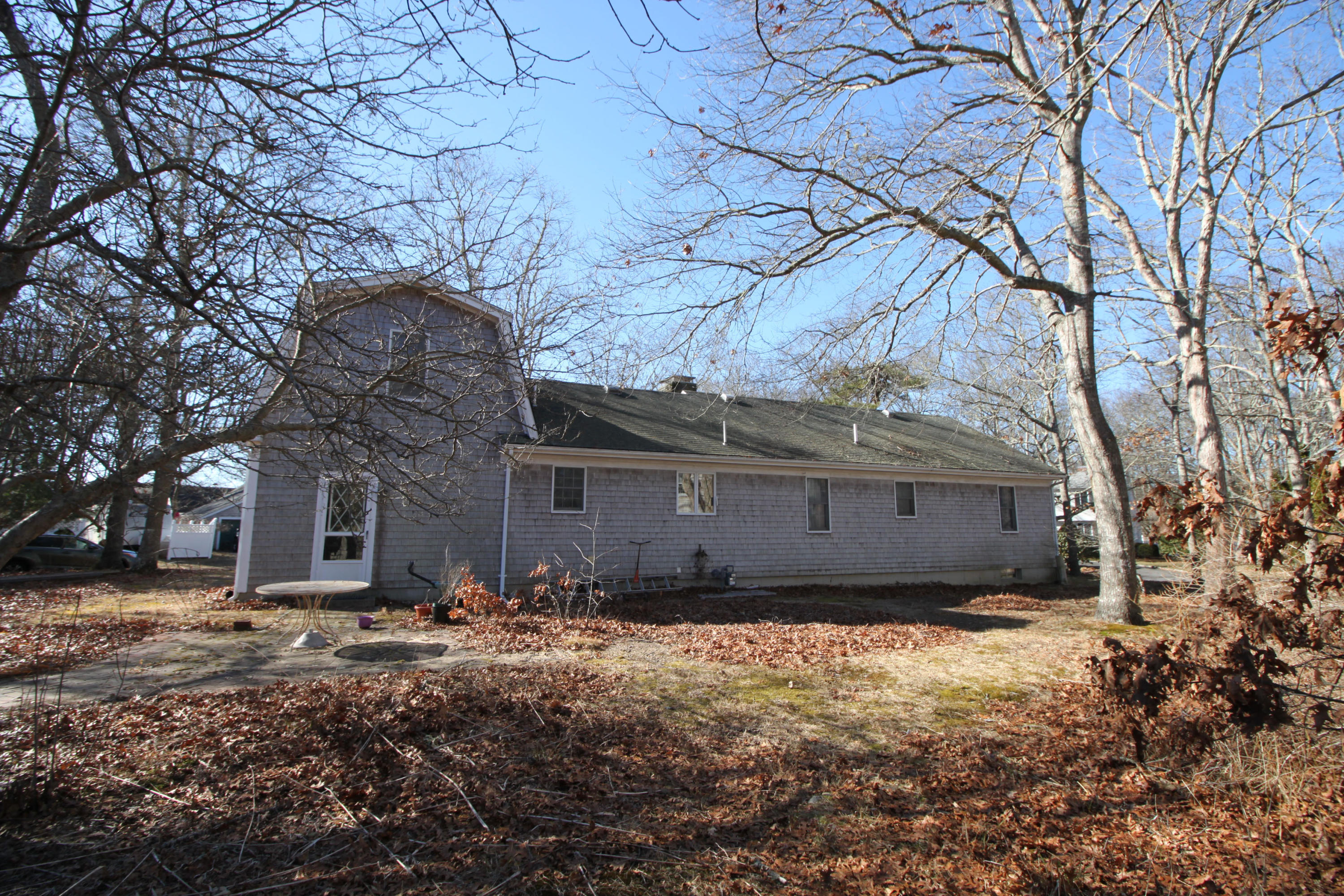 52 Moon Penny Lane Centerville, MA 02632 - Photo 8 of 12 a front view of a house with a yard