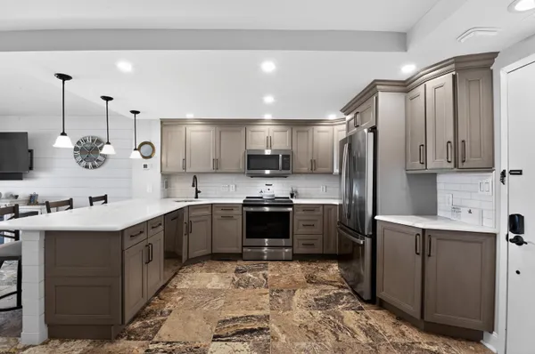 a kitchen with a sink stainless steel appliances and cabinets