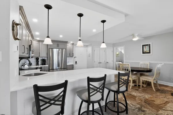a dining room filled with furniture and a chandelier