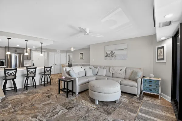 a living room with furniture a large window and a table