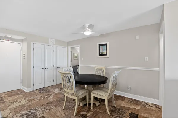 a view of a dining room with furniture and a potted plant
