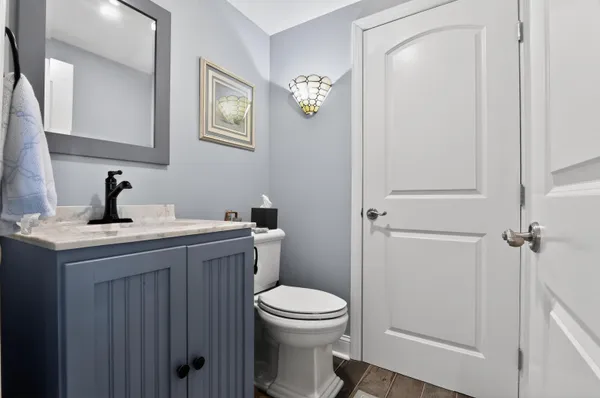 a bathroom with a toilet a sink and mirror