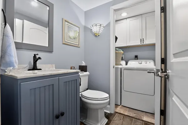 a bathroom with a toilet sink and mirror