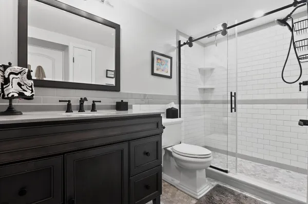 a bathroom with a sink toilet and shower
