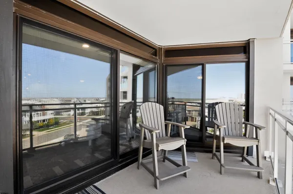 a dining room with furniture and a floor to ceiling window