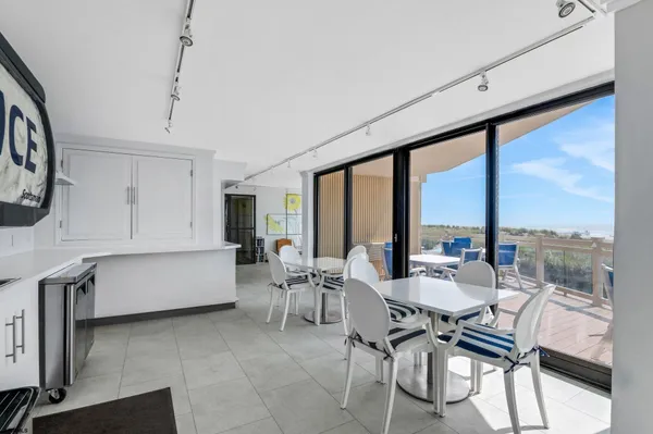 a dining room with furniture and a large window