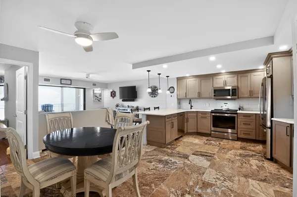 a large kitchen with a table and chairs
