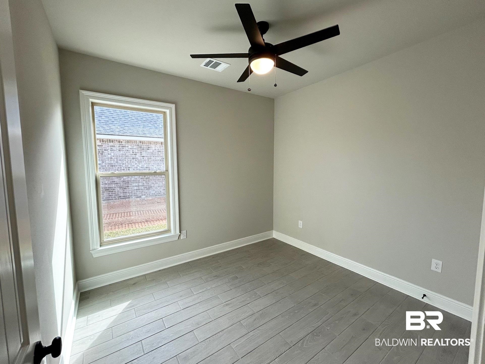881 Sumter Loop Foley, AL 36535 - Photo 12 of 19 Spare room featuring hardwood / wood-style floors and ceiling fan