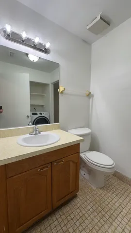 a bathroom with a toilet sink and mirror