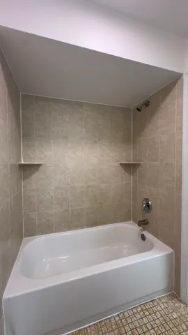 a bathroom with a bathtub and a shower